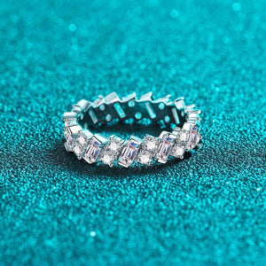 Silver ring with gemstones on a teal glittery background