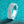 Elegant diamond ring on a teal glittery background