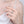 Silver ring on a hand against a neutral background