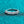 Silver ring with diamonds on a teal background