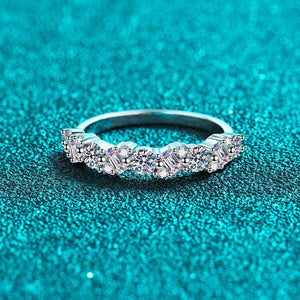 Silver ring with diamonds on a teal background