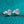 Pair of diamond stud earrings on a teal glitter background
