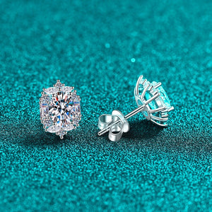 Silver stud earrings on a teal glittery background