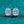 Pair of diamond earrings on a teal glitter background