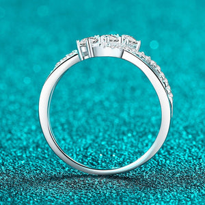 Silver ring with diamonds on a teal glittery background