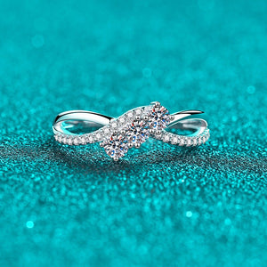 Silver ring with a large diamond on a teal glittery background