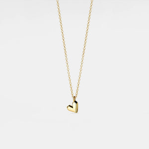 Gold heart-shaped pendant necklace on a light gray background