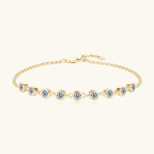 Gold bracelet with embedded crystals on a white background
