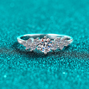 Silver ring with gemstones on a teal glittery background