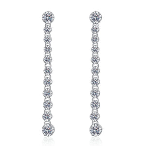 Pair of silver earrings with clear gemstones on a white background