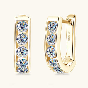 Gold hoop earrings with clear gemstones on a white background
