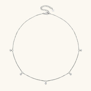 Silver necklace with small beads on a white background