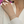 Silver bracelet on a person's wrist with a blurred background