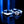 Two silver rings with one featuring a diamond on a reflective surface with blue lighting.