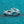 Silver hoop earrings on a teal glittery background