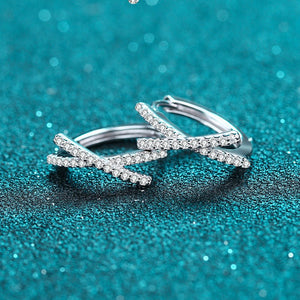 Silver hoop earrings on a teal glittery background