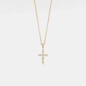 Gold necklace with a cross pendant on a light gray background