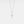 Silver cross pendant necklace on a light gray background