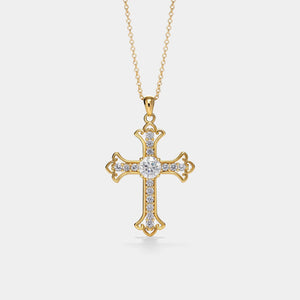 Gold cross necklace with diamonds on a light gray background