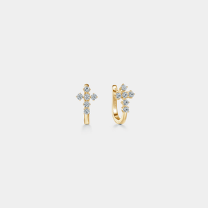 Gold earrings with diamond accents on a light gray background