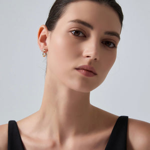 Close-up of a woman wearing a black top against a plain background