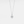 Silver necklace with a round pendant on a light gray background