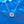 Silver necklace with a diamond pendant on a blue textured background