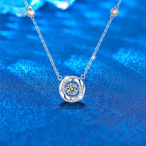 Silver necklace with a diamond pendant on a blue textured background