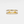 Gold ring with embedded diamonds on a light gray background