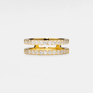 Gold ring with embedded diamonds on a light gray background