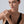 Woman wearing a black dress and diamond ring on a plain background