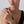 Close-up of a woman wearing a diamond ring on a plain background
