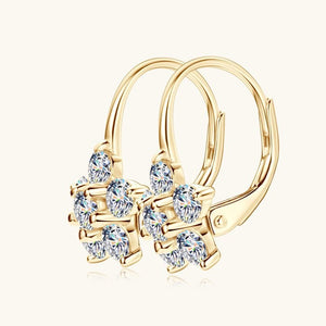 Gold hoop earrings with clear gemstones on a white background