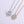 Two diamond necklaces on a light purple background