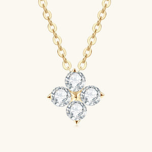 Gold necklace with a four-crystal pendant on a white background