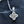 Silver necklace with a diamond pendant on a dark background