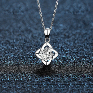 Silver necklace with a diamond pendant on a dark textured background