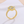 Gold ring with diamond-like stones on a light background