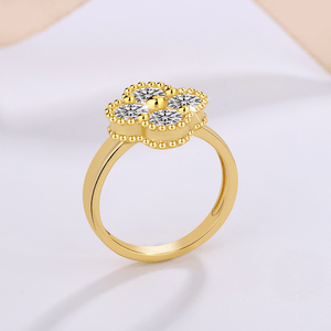 Gold ring with diamond-like stones on a light background
