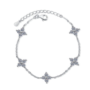 Silver bracelet with star-shaped charms on a white background