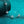 Silver bracelet with star-shaped charms on a teal background