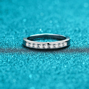 Silver ring with small diamonds on a blue glittery background