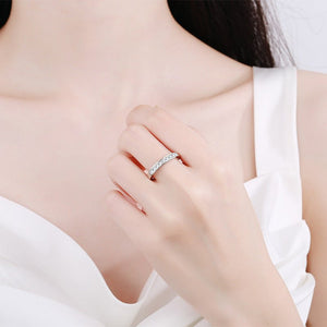Close-up of a hand wearing a silver ring with a white background