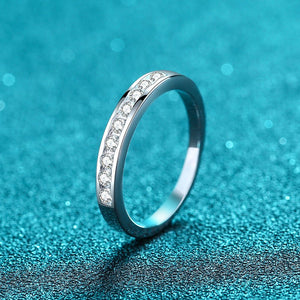 Silver ring with small diamonds on a blue textured background