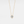 Gold necklace with a diamond pendant on a light gray background
