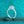 Silver ring with a large central gemstone on a teal glittery background