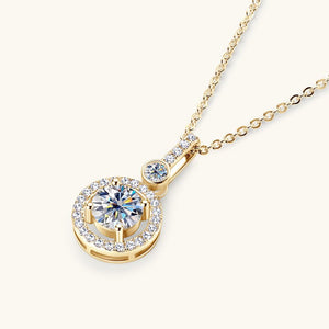 Gold necklace with a diamond pendant on a white background