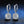 Pair of silver hoop earrings with round gemstones on a dark blue textured background