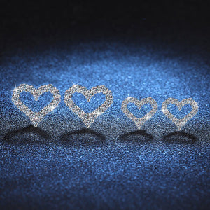 Set of heart-shaped jewelry on a dark blue textured background