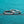 Two silver rings with diamond accents on a teal background